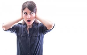 woman covering her ears, on a white background